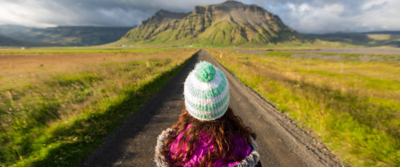 Young woman standing in the road in Iceland.